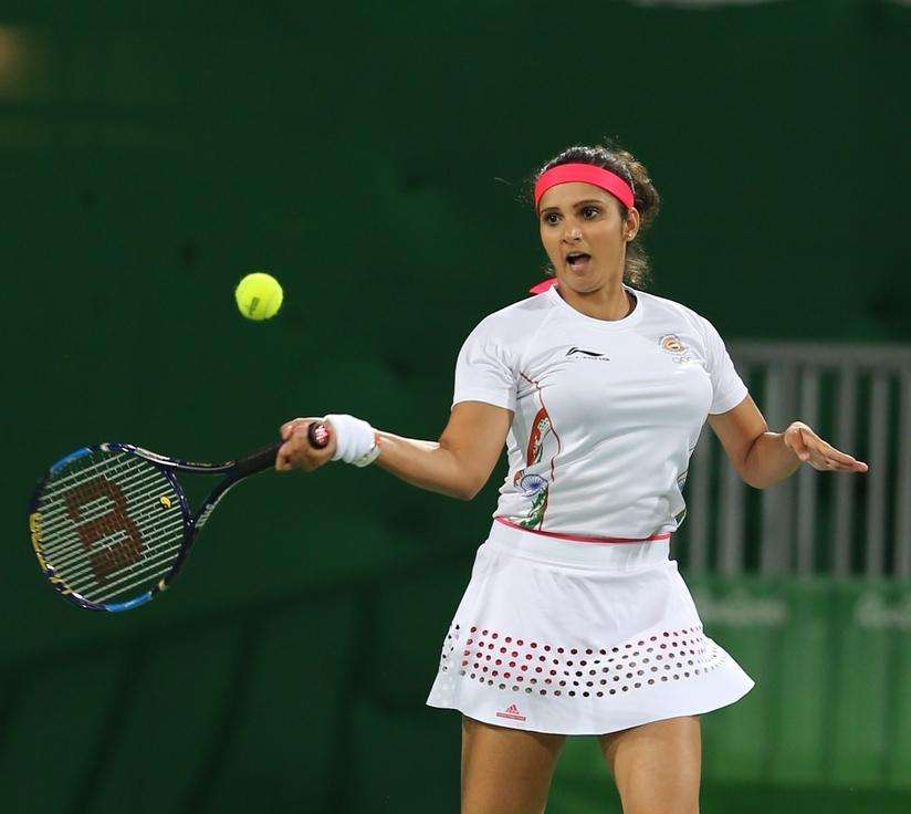 Rio de Janeiro: Indian tennis players Sania Mirza in action against Andy Murray and Heather Watson of Britain in mixed doubles tennis event in Rio de Janeiro on Aug. 12, 2016. Sania and Bopanna entered the semi-finals of the mixed doubles tennis event by defeating Andy Murray and Heather Watson of Britain in straight sets. (Photo: Seshadri Sukumar/IANS)