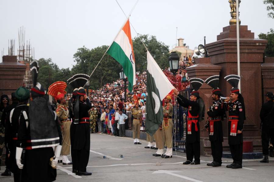 LAHORE, June 26, 2016 (Xinhua) -- Pakistani Rangers (black uniform) and Indian Border Security Force (BSF) personnel perform the flag off ceremony at the Pakistan-India Wagah Border near eastern Pakistan's Lahore on June 25, 2016. (Xinhua/Ahmad Kamal/IANS) by .