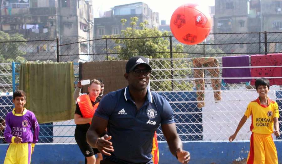 Kolkata: Former Manchester United player Dwight Yorke with budding footballers in Kolkata on Dec 10, 2016. (Photo: IANS) by .