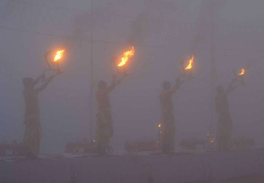 Varanasi: Priests perform Ganga aarti in Varanasi on a foggy day on Jan 6, 2017. (Photo: IANS) by .