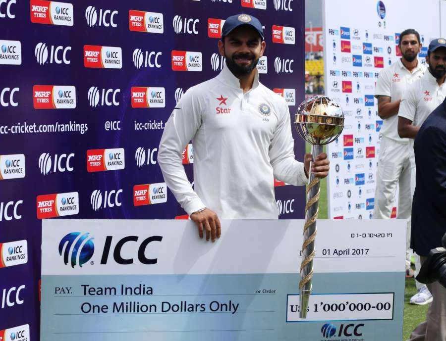 Dharamsala: Indian Captain Virat Kohli with the ICC Test Championship mace and cheque at a ceremony after winning the Test match series against Australia at Himachal Pradesh Cricket Association Stadium in Dharamsala on March 28, 2017. Indian cricket team has retained the ICC Test Championship mace and also won a cash award of USD one million for holding on to the top position in the Test Team rankings on the annual April 1 cut-off date. (Photo: Surjeet Yadav/IANS) by .
