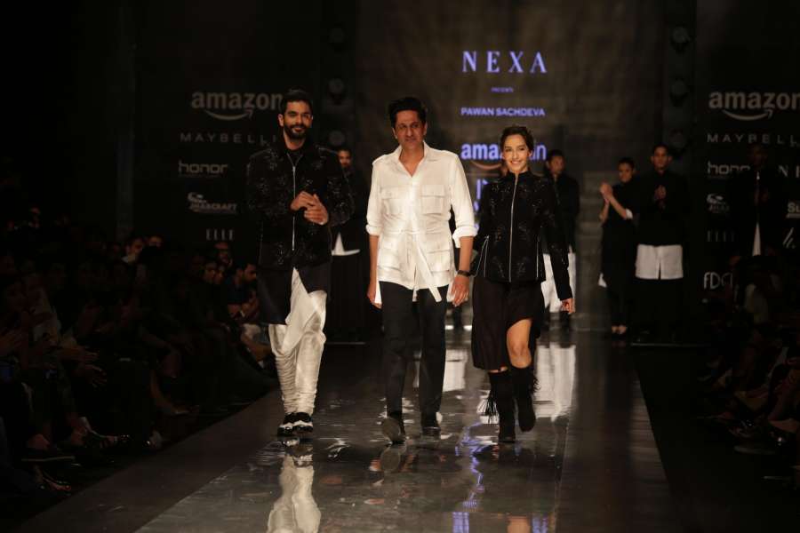 New Delhi: Showstopper actors Nora Fatehi and Angad Bedi walks the ramp for fashion designer Pawan Sachdeva during Amazon India Fashion Week - Autumn Winter's, in New Delhi, on March 19, 2017. (Photo: Amlan Paliwal/IANS) by .