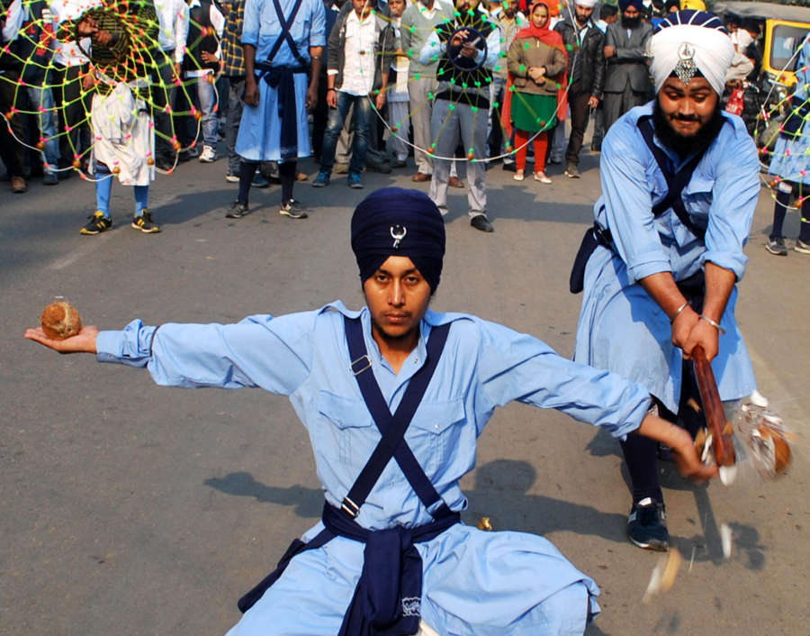 Young Sikh Nihangs or warriors demonstrate their 'Gatka' skills during a religious procession outside Golden Temple on the eve of 545 birth anniversary of Guru Nanak Dev the first Sikh Guru in Amritsar on Nov.16, 2013. (Photo: IANS) by IANS.