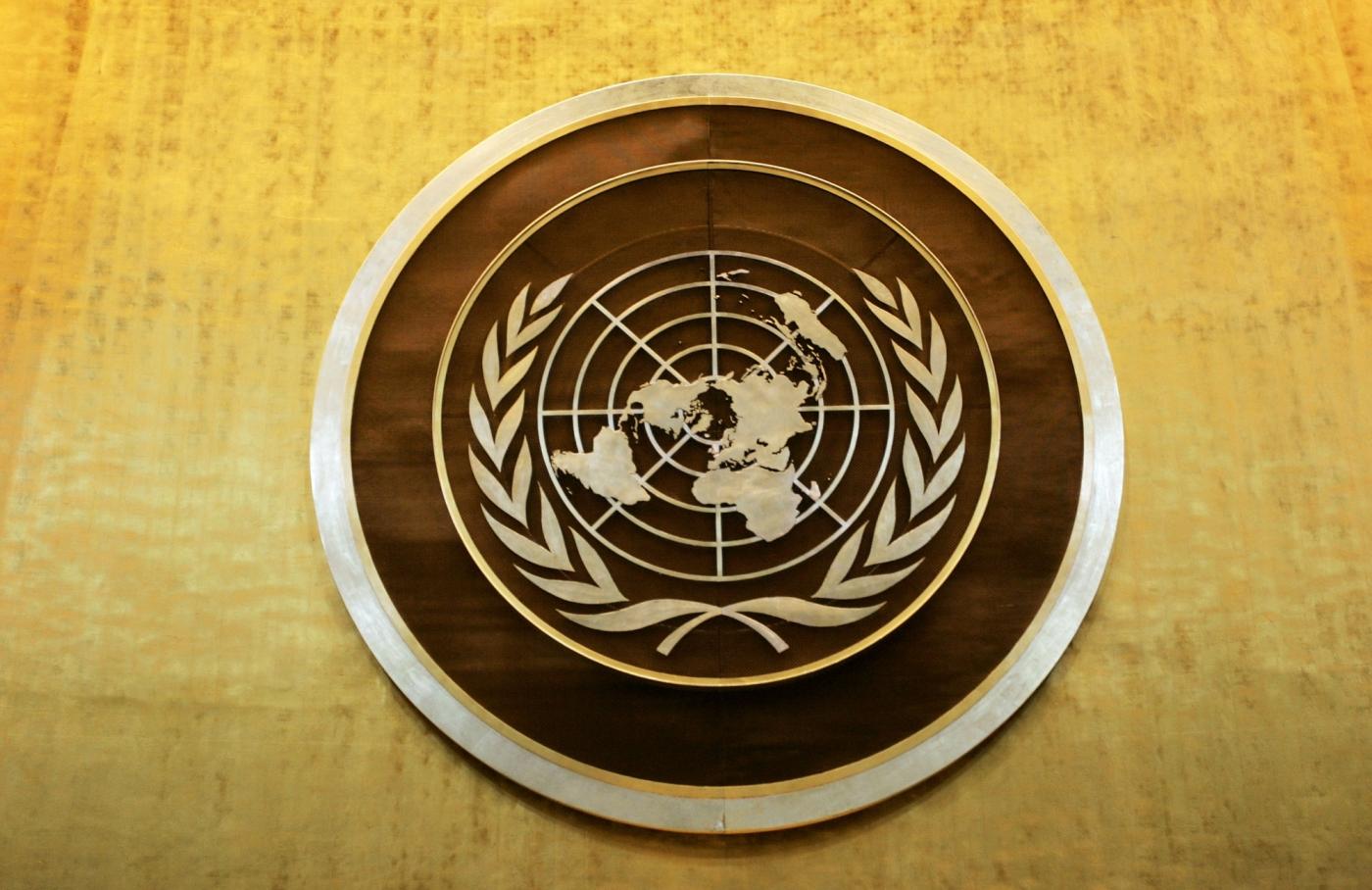 Plaque bearing the United Nations logo above the podium of the General Assembly Hall. (File Photo: Ryan Brown/UN Photo/IANS) by .