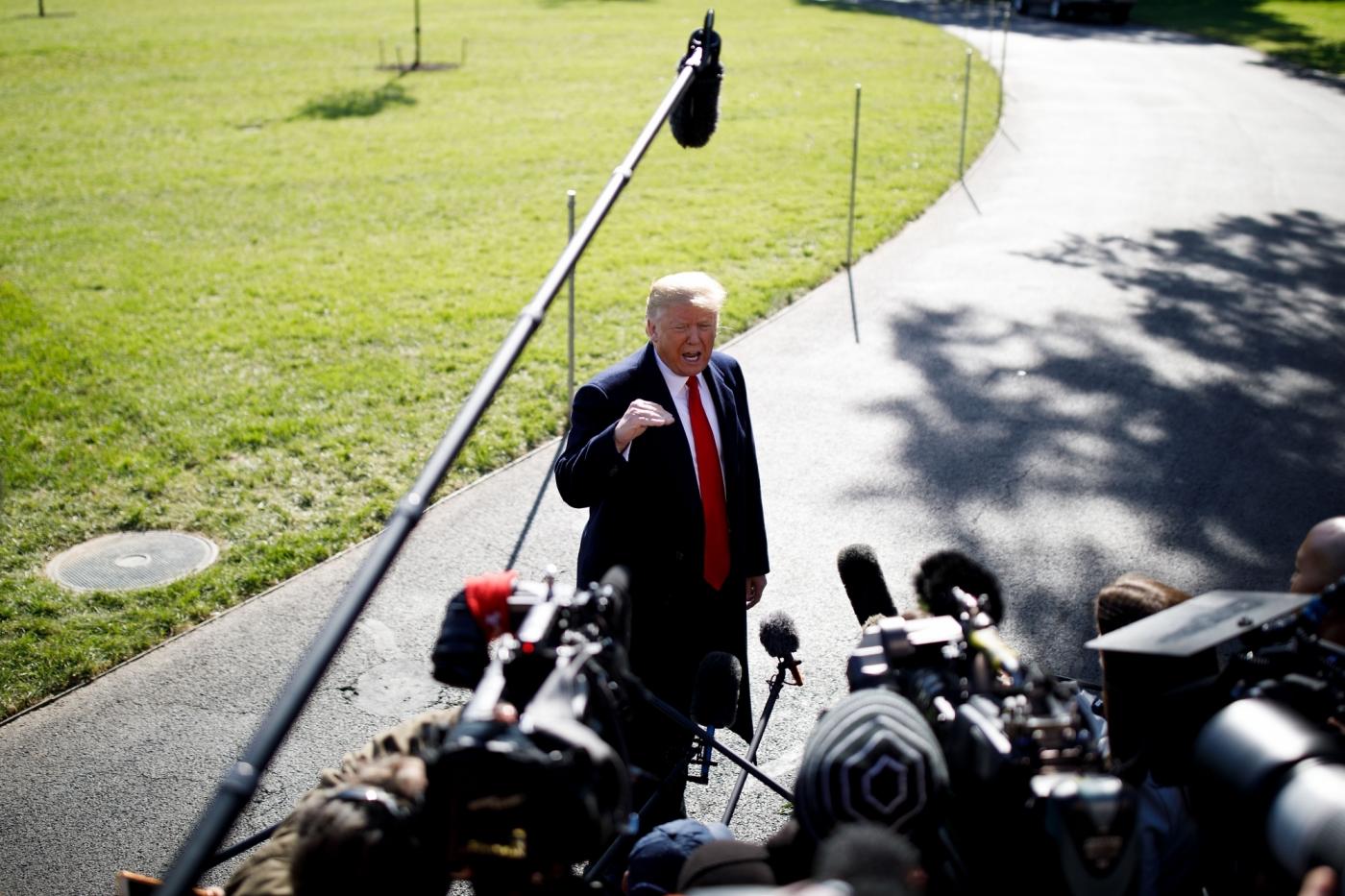 WASHINGTON, Oct. 22, 2018 (Xinhua) -- U.S. President Donald Trump speaks to reporters before departing from the White House in Washington D.C., the United States, on Oct. 22, 2018. Donald Trump said on Monday that his country will begin cutting off or reducing aid to three countries in Central America, citing migrant caravan heading to the U.S. border. (Xinhua/Ting Shen/IANS) by .