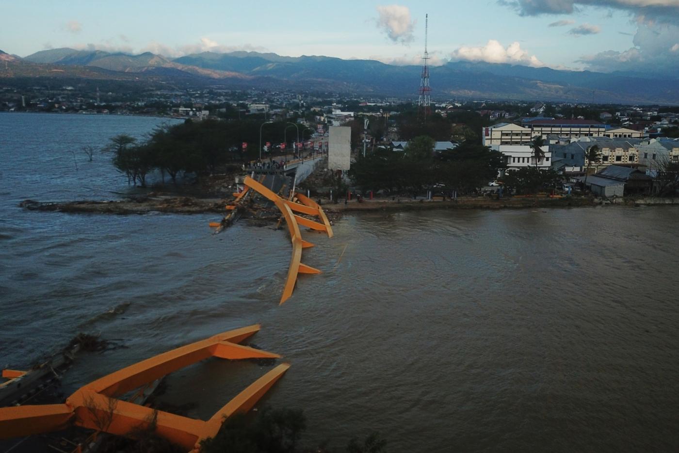 PALU, Oct. 8, 2018 (Xinhua) -- Photo taken on Oct. 8, 2018 shows the aerial view of a collapsed bridge after the earthquake and tsunami in Palu, Central Sulawesi, Indonesia. Death toll from multiple powerful quakes and an ensuing tsunami striking Central Sulawesi province of Indonesia on September 28 jumped to 1,948 on Monday and more than 5,000 others went missing, according to a disaster agency official here. (Xinhua/Wang Shen/IANS) by .