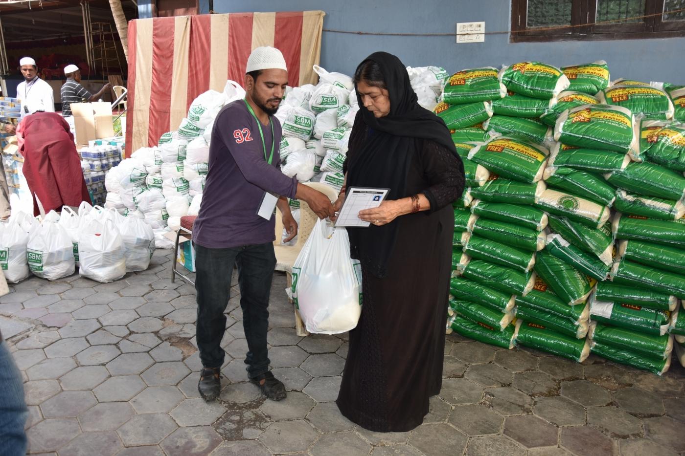 Ration kit being handed over to a woman during Ramadan by .