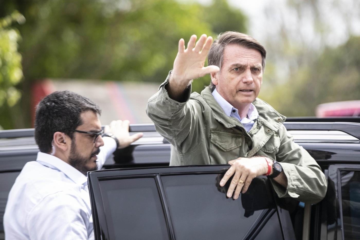 RIO DE JANEIRO, Oct. 28, 2018 (Xinhua) -- Presidential candidate Jair Bolsonaro waves to his supporters as he leaves a polling station in Rio de Janeiro, Brazil, on Oct. 28, 2018. Right-wing candidate Jair Bolsonaro won Brazil's presidential run-off on Sunday. (Xinhua/Li Ming/IANS) by .