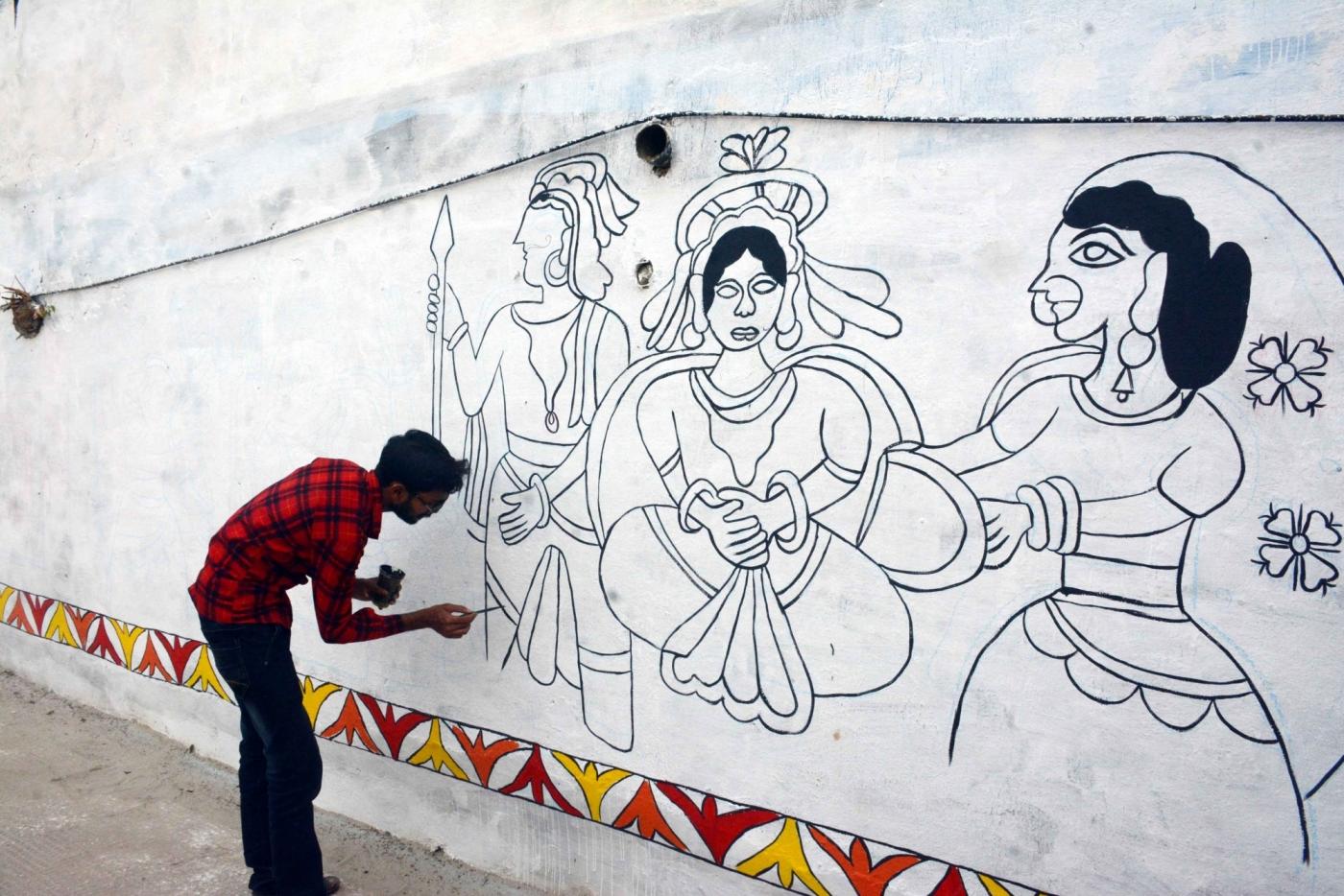 Patna: An artist decorates a wall with Madhubani art at Kali Ghat ahead of Chhath Puja in Patna, on Nov 10, 2018. (Photo: IANS) by .