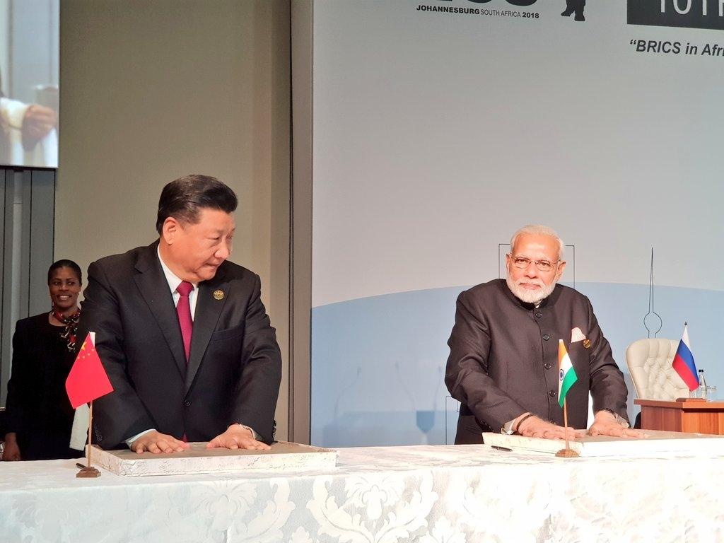 Maropeng: Prime Minister Narendra Modi and Chinese President Xi Jinping leave their hand impression on clay, for a symbolic demonstration of our connect to the Cradle of Humankind in Maropeng in South Africa on July 26, 2018. (Photo: IANS/MEA) by .