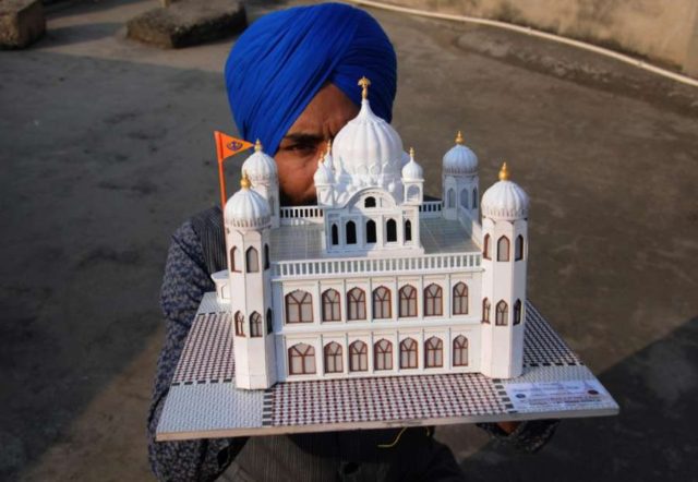 Amritsar: Paper artist Gurpreet Singh shows a model of Kartarpur Sahib, the final resting place of Guru Nank Dev, created by him, on the eve of the first Sikh Guru's birth anniversary, in Amritsar on Nov 22, 2018. (Photo: IANS) Amritsar: Paper artist Gurpreet Singh shows a model of Kartarpur Sahib, the final resting place of Guru Nank Dev, created by him, on the eve of the first Sikh Guru's birth anniversary, in Amritsar on Nov 22, 2018. (Photo: IANS) by .