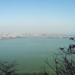 Dianchi Lake as seen from the top of Western Hills. Kunming city is in the background. by .