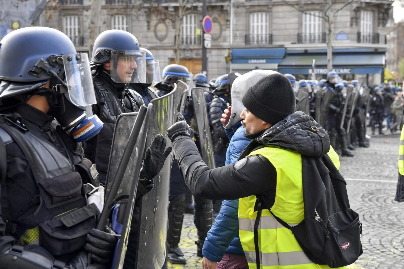PARIS, Dec. 8, 2018 (Xinhua) -- A protester confronts police near the Arch of Triumph in Paris, France, on Dec. 8, 2018. Riot police fired tear gas and water cannon at "Yellow Vests" protesters marching in Paris on Saturday in the fourth week-end action despite President Emmanuel Macron's series of concessions. (Xinhua/Chen Yichen/IANS) by .