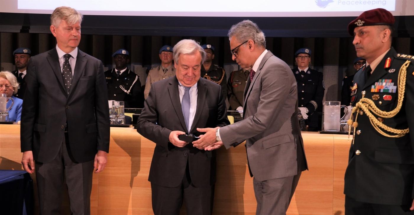 United Nations Secretary-General Antonio Guterres presents to India's Permanent Representative Syed Akbaruddin, right, the Dag Hammarksjold Medal honouring Indian peacekeeper Jitender Kumar, a police officer who laid down his life while serving the UN Organization Stabilization Mission in the Democratic Republic of the Congo (MONUSCO). At left is Jean-Pierre Lacroix, the Under-Secretary-General for Peace Operations. (Photo: Indian Mission/IANS) by .