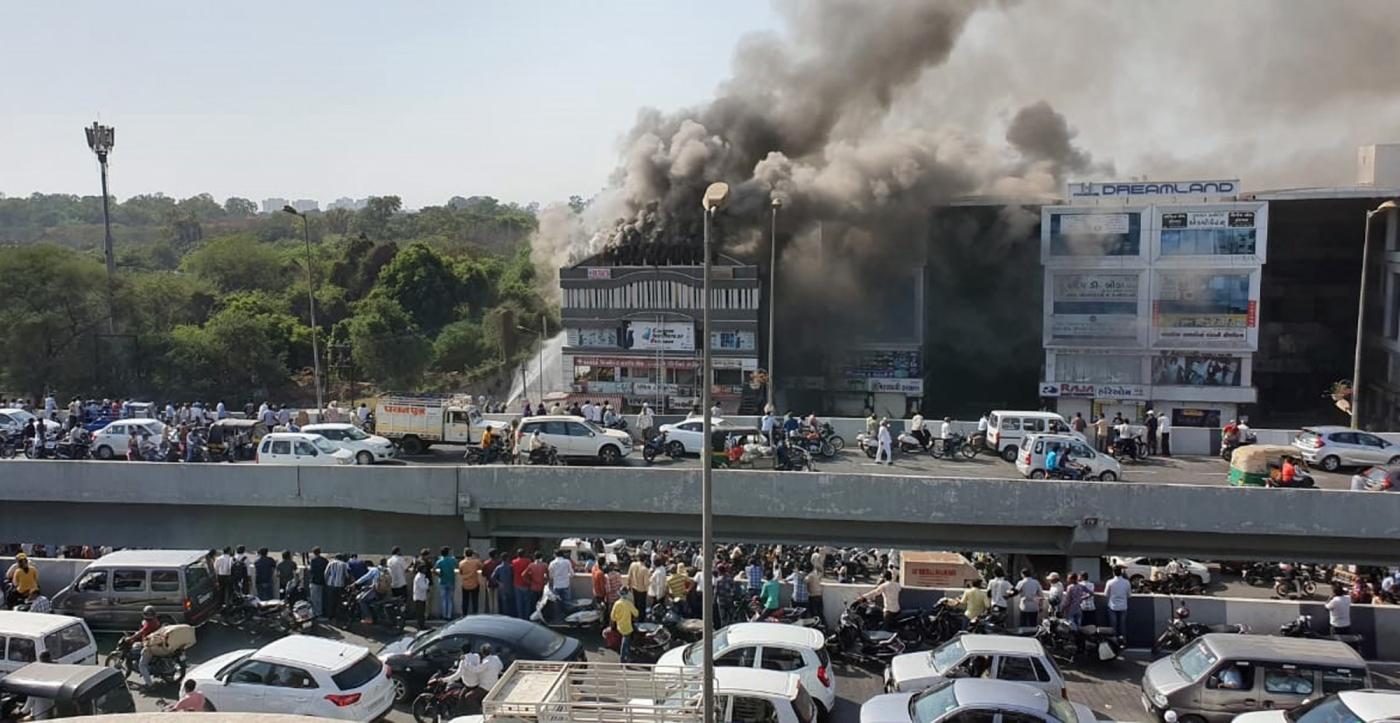 Surat: Fire fighting operations underway after a massive fire broke out at a coaching centre atop a four-storey building, in Sarthana area of Gujarat's Surat on May 24, 2019. 17 students were killed in the incident. (Photo: IANS) by .
