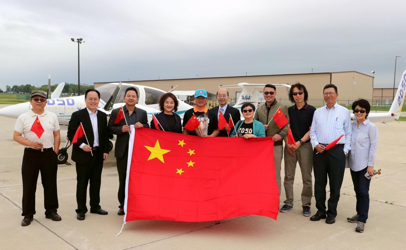 CHICAGO, June 10, 2019 (Xinhua) -- Zhang Bo (5th L) poses for photos in front of his aircraft while receiving a warm welcome from family members and friends at an airport in Chicago, the United States, on June 9, 2019. After flying 68 days and making 50 stops, 57-year-old Bo Zhang completed his second around-the-world flight and landed in Chicago on Sunday morning. On April 2, Zhang kicked off the flight in the same airport in Chicago. In 68 days, he flied through 21 countries in three continents and over three oceans, with total mileage reaching 41,000 kilometers. (Xinhua/Wang Ping/IANS) by . 