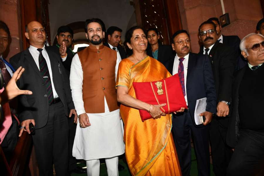 New Delhi: Union Finance and Corporate Affairs Minister Nirmala Sitharaman carrying budget papers wrapped in a red cloth, accompanied by Union MoS Finance and Corporate Affairs Anurag Thakur and other officials of the Finance Ministry, leaves for the Parliament to present the Union Budget 2020-2021, in New Delhi on Feb 1, 2020. (Photo: IANS) by .