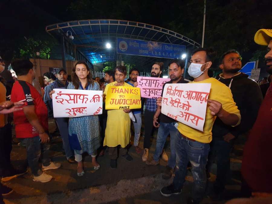 New Delhi: People hold posters outside the Tihar Jail ahead of the hanging of four convicts in the 2012 Nirbhaya rape case, in New Delhi on March 20, 2020. (Photo: IANS) by .