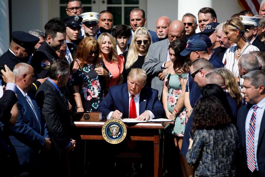 WASHINGTON, July 29, 2019 (Xinhua) -- U.S. President Donald Trump (C) participates in a signing ceremony for the "Permanent Authorization of the September 11th Victim Compensation Fund Act" at the White House in Washington D.C., the United States, on July 29, 2019. U.S. President Donald Trump on Monday signed into law a bill that extends funding for victims of the Sept. 11 terror attacks. (Photo by Ting Shen/Xinhua/IANS) by .