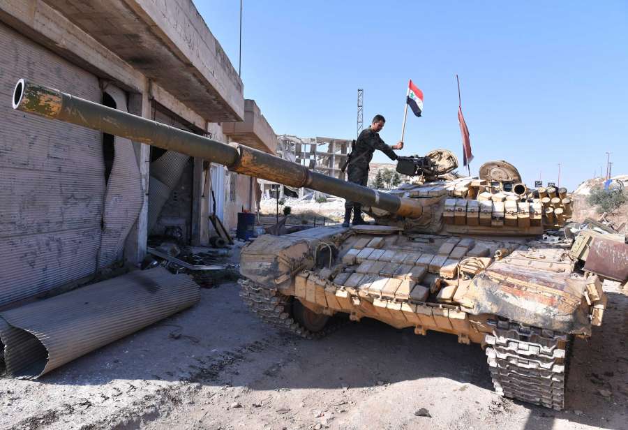 IDLIB (SYRIA), Aug. 24, 2019 (Xinhua) -- A Syrian soldier puts a Syrian flag on the top of a tank in the town of Khan Shaykhun in the southern countryside of Idlib province, Syria, on Aug. 24, 2019. The Syrian army on Friday fully secured the entire northern countryside of the central province of Hama for the first time since 2012, the state media reported. (Photo by Ammar Safarjalani/Xinhua/IANS) by .