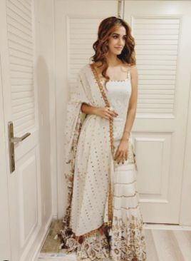 Actress Disha Patani chose a pristine white ensemble for the mahurat puja of her upcoming film "Radhe", starring Salman Khan and directed by Prabhudheva. This is the second time Disha will share screen space with superstar Salman after "Bharat". by .