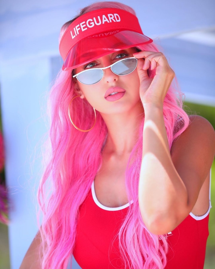 Actress Nora Fatehi in her latest new picture has got temperature rising as she transformed into a sizzling red-hot Barbie. In her latest image on Instagram, Nora is seen in a bright red tank top and a red cap captioned "lifeguard" and a bubble gum pink wig, making her look like a stunning barbie doll. by .