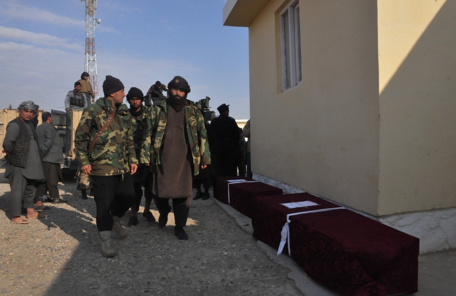 SHIBERGHAN, Dec. 30, 2019 (Xinhua) -- Afghan security force members walk past coffins of comrades killed in a checkpoint attack by Taliban militants in Faiz Abad district of Jawzjan province, Afghanistan, Dec. 30, 2019.n A total of 14 Afghan security force members were killed after Taliban militants stormed a security checkpoint in Afghanistan's northern province of Jawzjan on Monday, a provincial government spokesman said. (Photo by Mohammad Jan Aria/Xinhua/IANS) by .