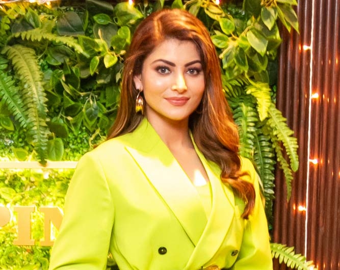 Actress Urvashi Rautela is grabbing all the attention with her latest neon look. She was recently spotted at Pepper & Pint restaurant in Mumbai, wearing a neon green coloured coat dress. Urvashi also carried a black belt and black heels, adding more style to the dress. In one of the images, she is seen holding diyas and giving a huge smile. by .