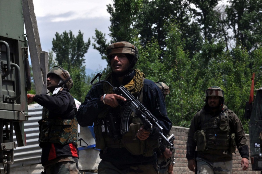 Pulwama: A security personnel during cordon and search operation after two militants were killed in a gunfight with the security forces, at Panzgam in Jammu and Kashmir's Pulwama district, on May 18, 2019. One of the slain militants has been identified as Showkat Ahmad Dar, a resident of Panzgam village. He belonged to the Hizbul Mujahideen (HM) outfit. (Photo: IANS) by .