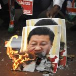 Bengaluru: Youth Congress activists burn the posters of Chinese President Xi Jinping during protest against the brutal attack on Indian Army personnel at Galwan valley at the Line of Actual Control that has killed 20 Indian soldiers during the Indo-Chinese face off in Ladakh; in Bengaluru on June 17, 2020. (Photo: IANS) by .