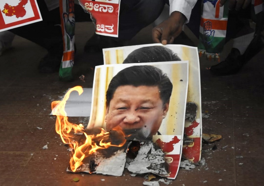 Bengaluru: Youth Congress activists burn the posters of Chinese President Xi Jinping during protest against the brutal attack on Indian Army personnel at Galwan valley at the Line of Actual Control that has killed 20 Indian soldiers during the Indo-Chinese face off in Ladakh; in Bengaluru on June 17, 2020. (Photo: IANS) by .
