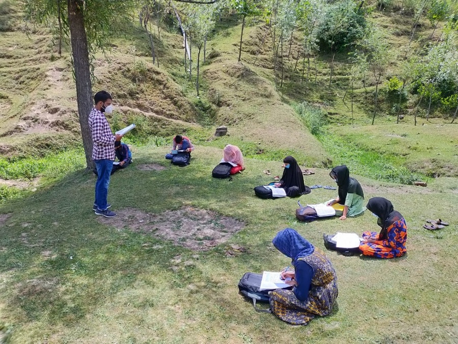 Kandi: Students study during community classes that have been started from today, in Kandi area of Baramulla district in Jammu and Kashmir on July 8, 2020. (Photo: IANS) by .